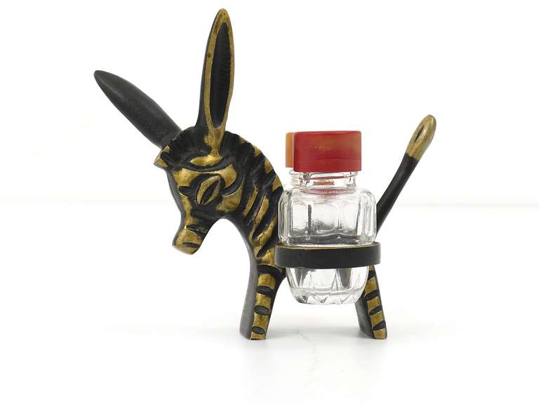 A very charming Viennese shaker set, displaying a zebra from the left side and a donkey from the other side. A very humorous design by Walter Bosse, executed by Baller Austria in the 1950s. Made of brass, glass and bakelite. Marked.