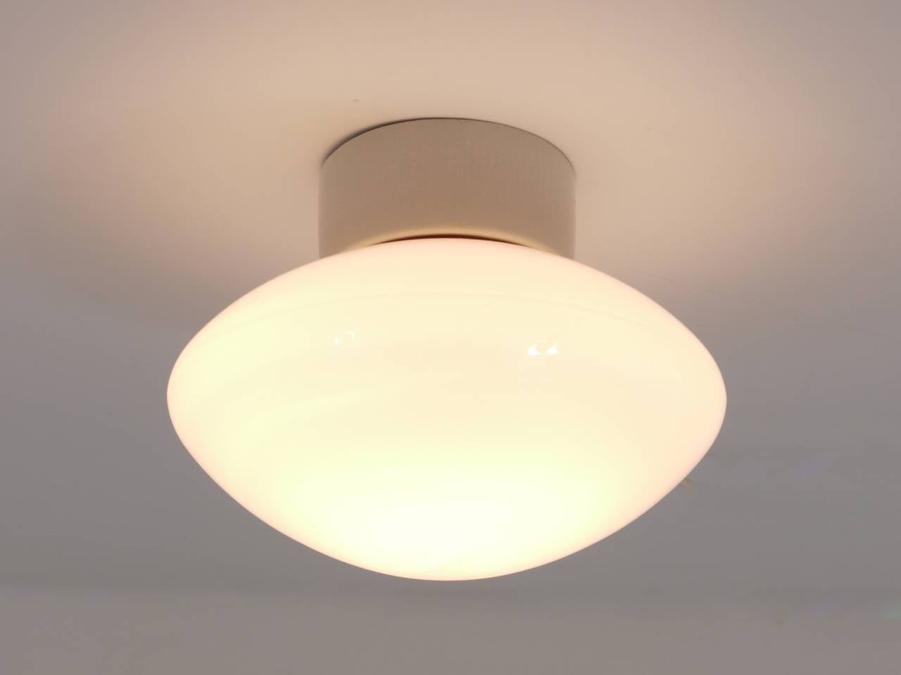 A beautiful German Bauhaus lamp, to use as ceiling lamp or sconce from the 1940s. Designed by Prof. Wilhelm Wagenfeld, executed by Lindner/Bamberg. Has a white porcelain base and a nice shaped opal glass lampshade. In very good condition.