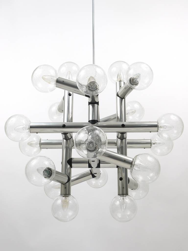 One of three identical huge Austrian Mid-Century Atomium chandeliers, designed and executed by Kalmar Vienna in 1969. Vey impressive pieces, made of nickel-plated metal with nice ball lampshades made of clear class with small bubbles. In excellent