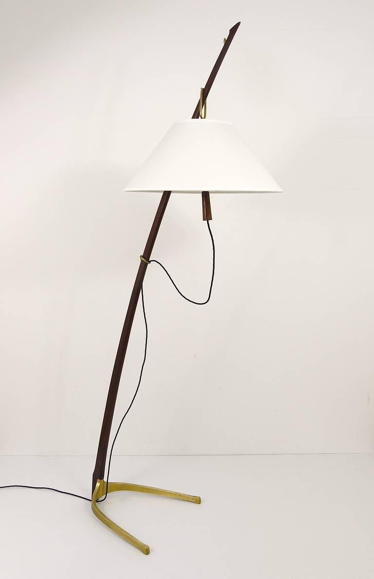 A beautiful floor lamp, designed and executed by J.T. Kalmar Austria. The lampshade is adjustable to three different heights, the lamp has a very nice brass base. Refurbished lampshade. In excellent condition, rewired, nice patina on the brass.