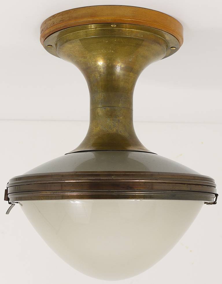 A very rare and beautiful ceiling lamp, designed and executed in the 1930s by Goerz Werke, Berlin. Has a brass base, a hemispheric, satined opal glass lampshade and a reflecting mirror inside. In very good condition, marked on the lampshade.
