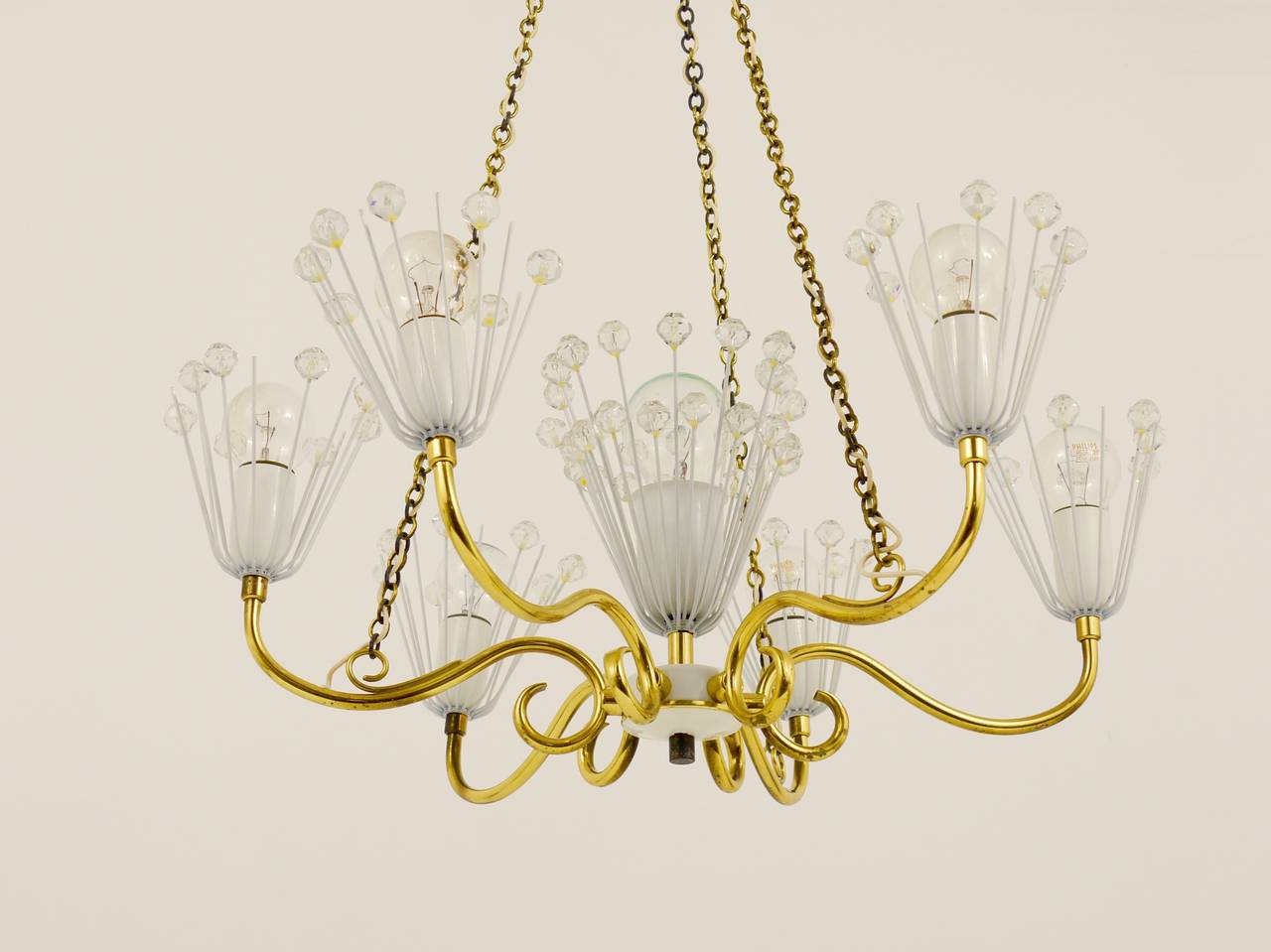 A wonderful Austrian brass chandelier with 6 arms, designed by Emil Stejnar, executed by Rupert Nikoll in the 1950s. In very good condition. 

Measurements: diameter 20 in, total height 24 in;, height without chains: 8 in.