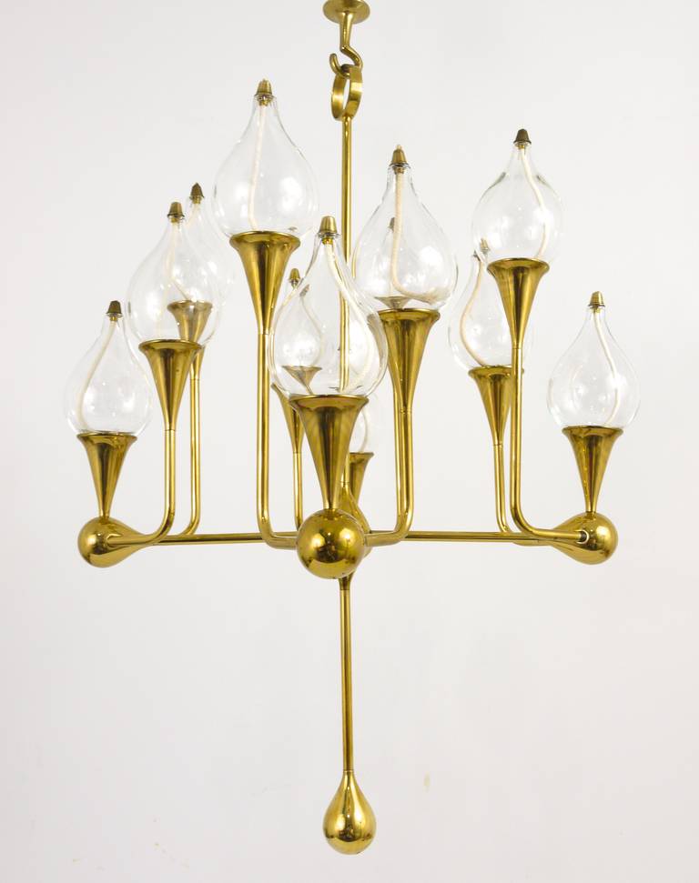 A very beautiful brass chandelier / candle holder with 12 arms /12 glass oil candles. Designed by Freddie Andersen, made in Denmark in the 1970s. Excellent condition. 