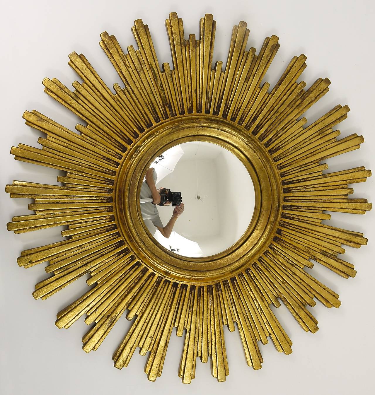 One of three beautiful and big sunburst/starburst gilt wall mirror with convex mirror glass from France, dated around 1950. A very beautiful and decorative object in very good condition. Diameter 22