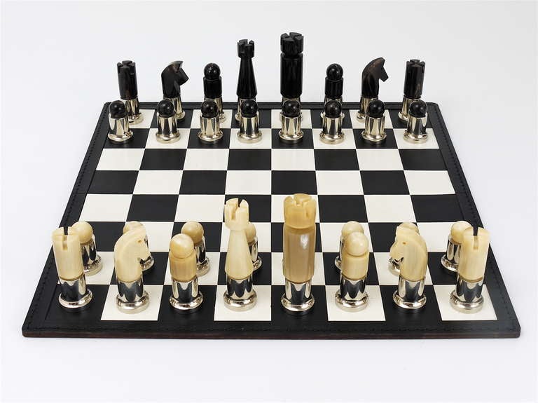 Very exceptional and beautiful chess game/chess men in original woodbox, plus black & white leather chessboard, designed by Austrian Modernist Carl Aubock. Discontinued vintage chess game, made of light and dark cow horn and nickel-plated metal.  In