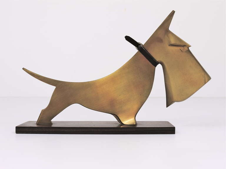 Rare art deco sculpture, displaying a lovely scotch terrier, made of brass on a wooden base. Designed and executed in Vienna by Carl Aubock (1900- 1957), dated around 1928-1930. It has a total length of 11