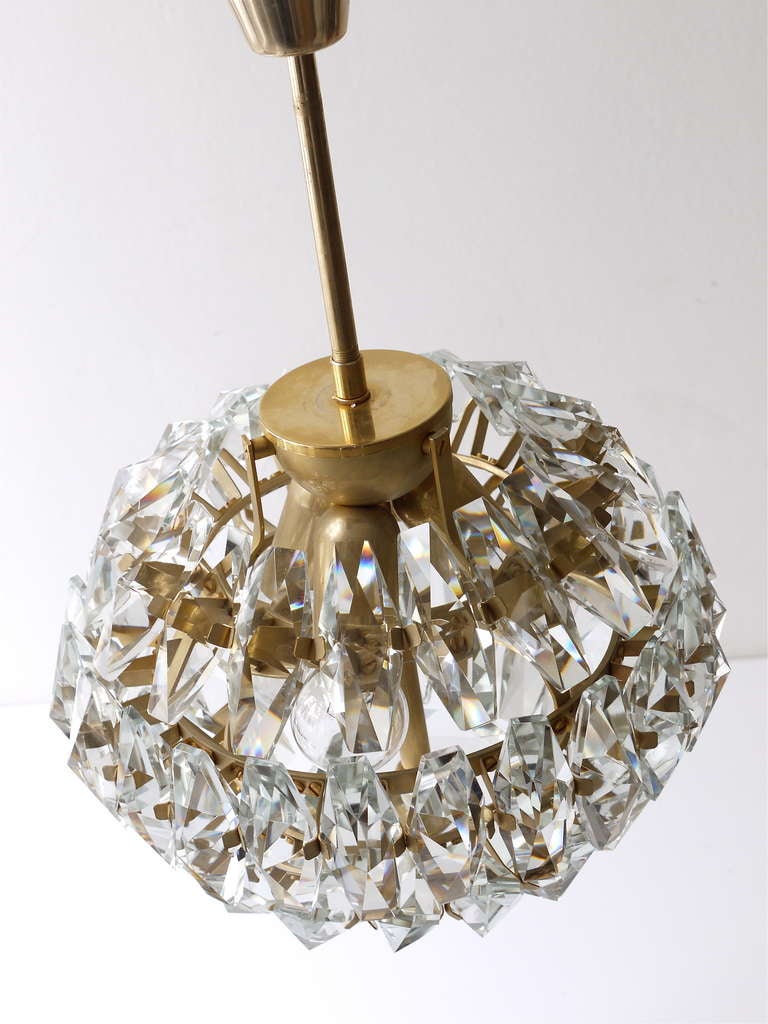 Exceptional and charming 1950s ball chandelier, executed by Lobmeyr Vienna in the 1950s. Fully covered with 60 very big, sparkling faceted crystals. The crystals are 3
