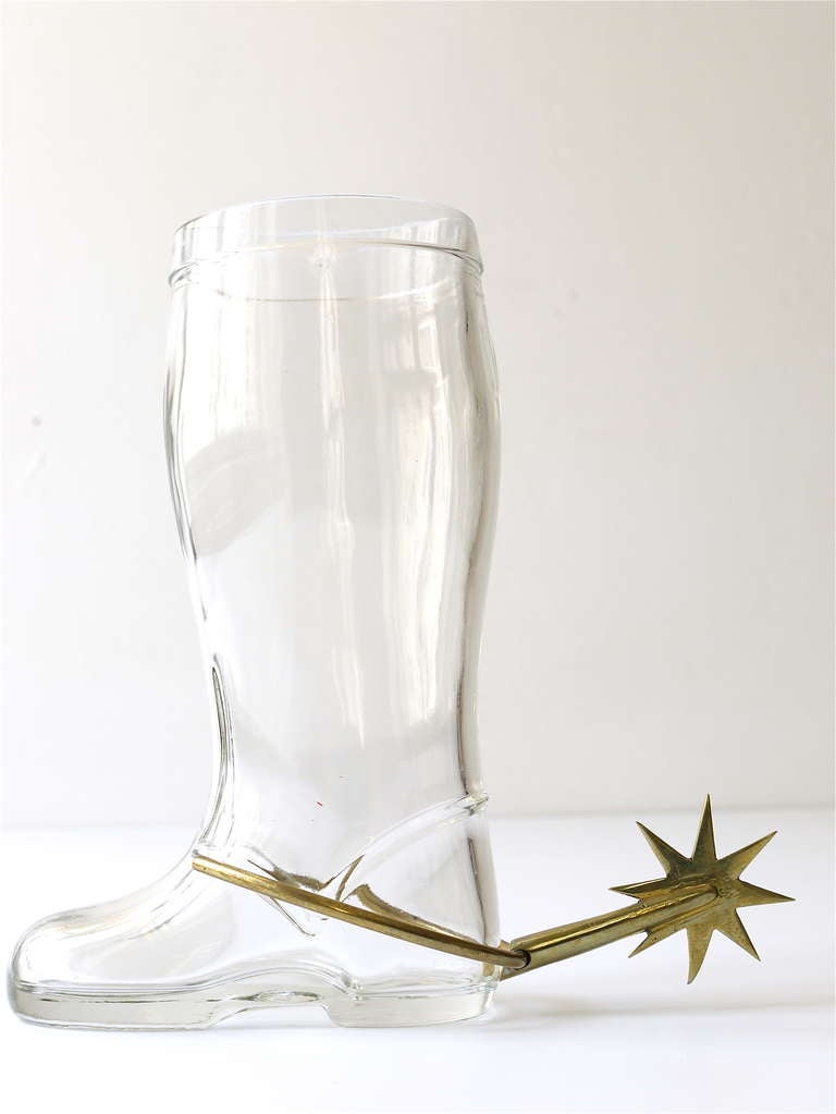 A sculptural  pitcher / vase / caraffe / big drinking glass in the shape of a big boot with a handcrafted brass spur. Designed and executed in the 1950s by Carl Auböck Vienna, Austria. Excellent condition, height: 7 1/2 in.