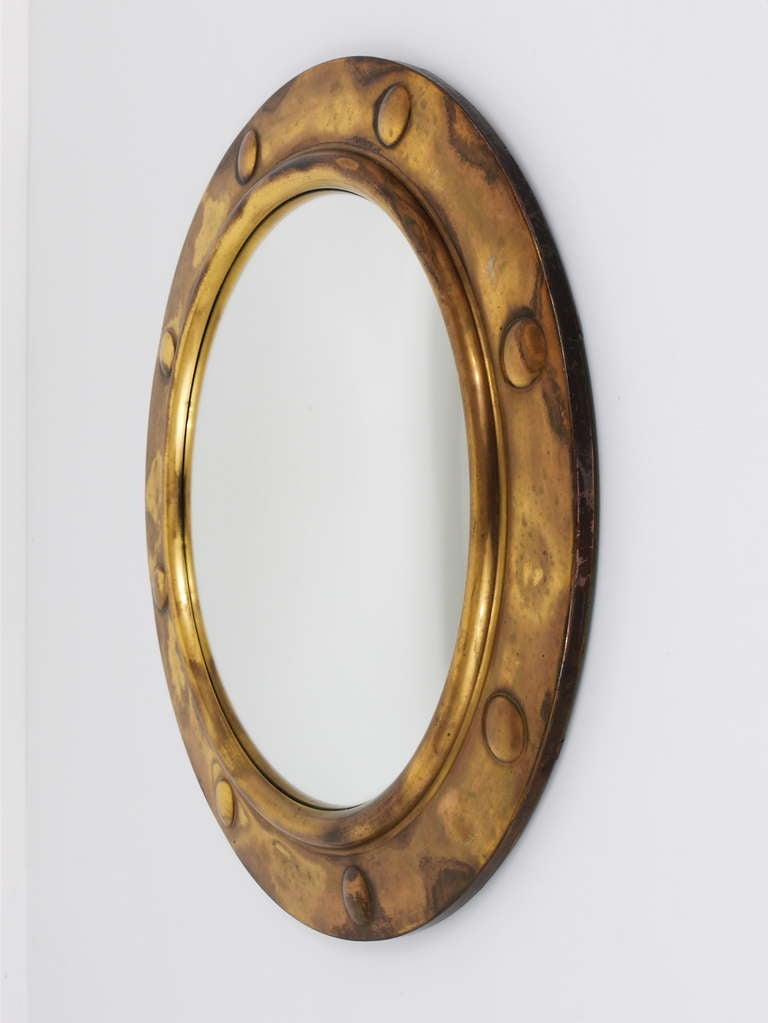 A very beautiful round Porthole Brass mirror from the 1950s, made in France. Has a nice brass frame and a convex mirror glass. Very good condition, nice patina on the brass. Total diameter 19