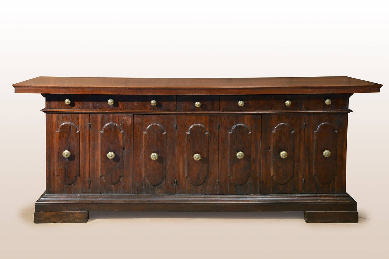 An incredible credenza,  with four door and seven drawers on the front, overall paneled and in fantastic condition of use. The top with carved board.
Perfect patina and proportions. 
Bologna , XVII century, beginning.
 cm 110 x 270 x75