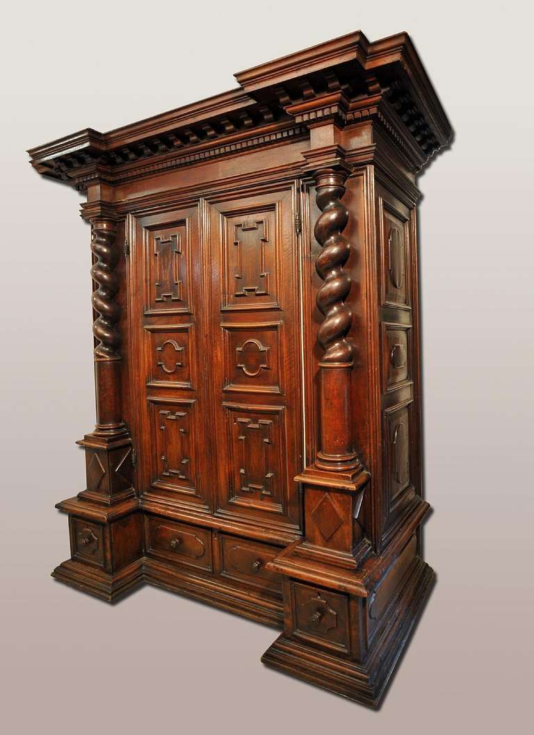 A very rare  17th c. walnut cupboard Italy Emilia Romagna- Lombardia
Overall carved: the top with dentil motives, two doors on the front over three drawers.
The cupboard is decorated with two frontal columns.
On the front and on the sides we can