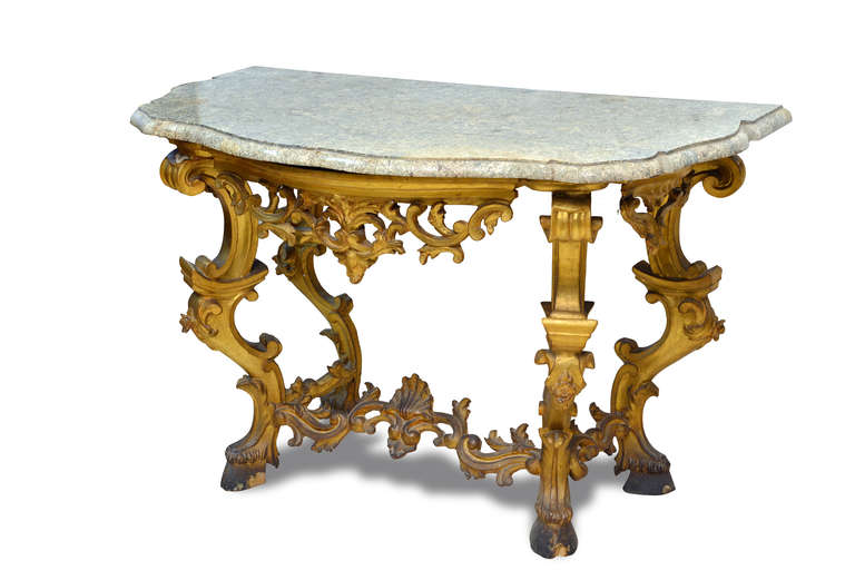 A very elegant pair of italian wall tables. overall carved and gilded.
Four moulded feet above a very rare marble top.

Italy, Bologna Sec XVIII

cm 80 x 130 x 60
