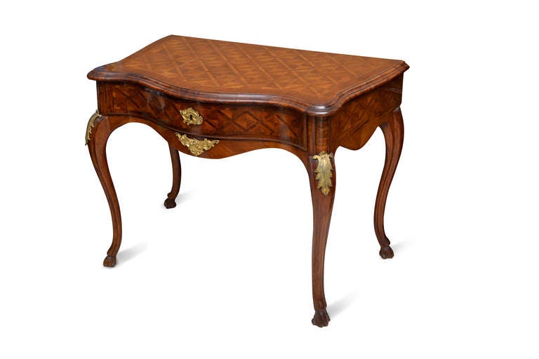 An 18th century roman console, overall inlaid and veneered with bois de rose and boise de violette wood.<br />
The front, the top, the sides moulded over four moulded legs.<br />
Some bronze decoration are present.<br />
 cm 85 x 110 x 61