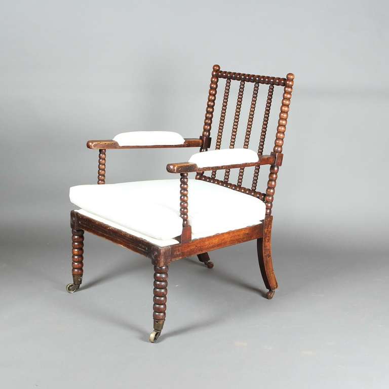 A 19th century beech bobbin armchair - recently upholstered in calico