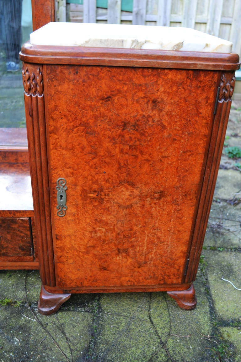 This stunning Art Deco vanity-dressing table belonged to a doctor (GP) and is made in the late 1920s of bookmatched burr walnut with the most amazing detail on the corners (see detail photographs). The vanity consists of the central dressing table