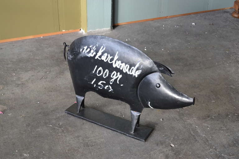 This rare sheet iron butcher's sign with full bodied silhouette in de form of a pig was used for the meat on offer, which was written on the pig's belly with a piece of chalk. The pig, almost one meter long, was placed outside the butcher's shop to