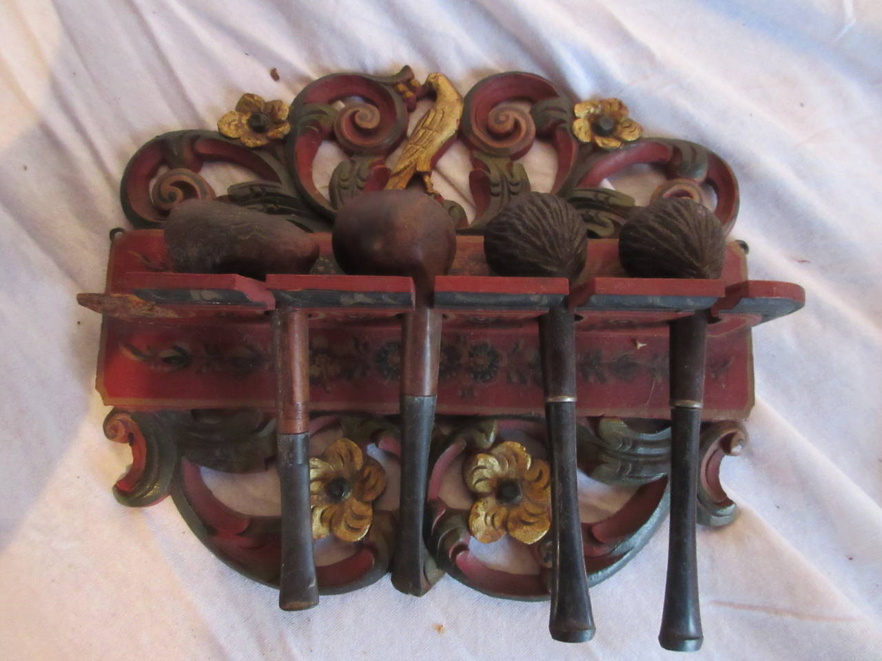 In our collection Tabacology:

Charming antique pipe rack painted in Hindeloopen(see below) attributed to Arend Roosje (1869-1914).
This pipe rack could hold four pipes; the pipes in the rack, three of which are old ( Bruyere) Briar pipes come