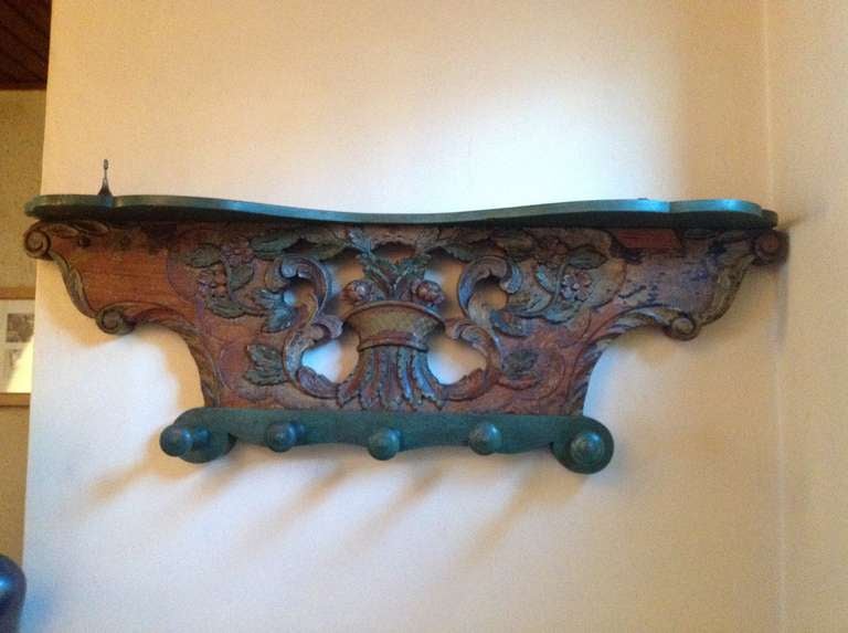 Louis XVI carved and polychrome wainscot probably from a children's goats cart.
With a hat shelf and a row of wooden pegs the wainscot has been adapted into a coat-rack, the additions in a perfect matching green.

The aforementioned sizes are