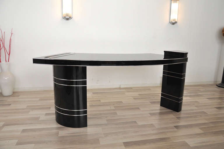 Amazing Bauhaus desk with a curved tabletop and a wonderful finish. It features a unique shape, elegant chrome bars and two illuminated glass rods inserted in the tabletop. A dreamlike piece of furniture restored by hand in our manufactory in