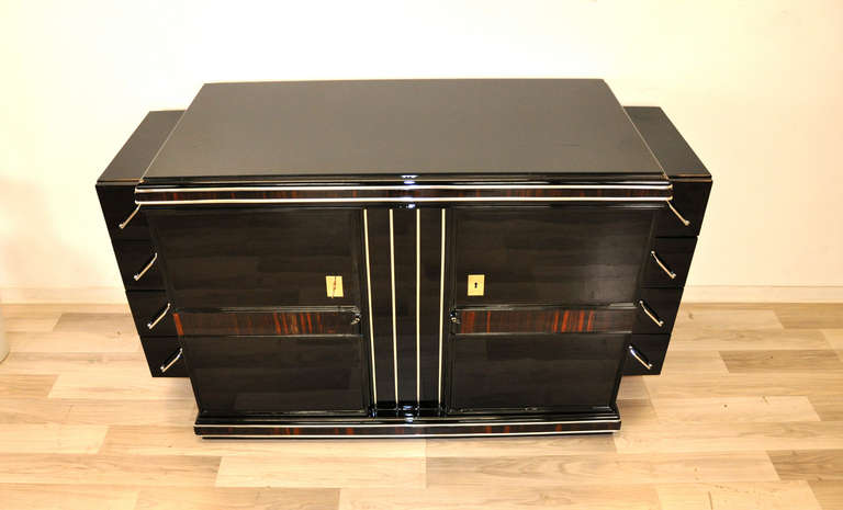 Belgian Art Deco Sideboard

        - Wonderful Body
        - Makassar veneer
        - Chrome strips
        - Hand-polished
        - High Gloss / Black
        - Clean interior

Any questions? Please don't hesitate to contact us.