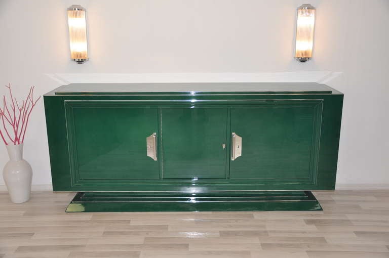Unique Art Deco sideboard in jaguar racing green:

    - Racing green high gloss lacquer
    - Beautiful body graders
    - 2 large double doors
    - Large chrome fittings
    - Chrome strips
    - Hand-polished

Country of Origin:
Year