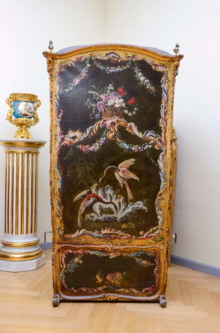 18th Century gilded sedan chair in carved with partially restored gilt, painted on all faces including the back. Flower scrolls, flower and fruit baskets, knots and ribbons and birds decor. The windows frame and structure are outlined by a scrolls