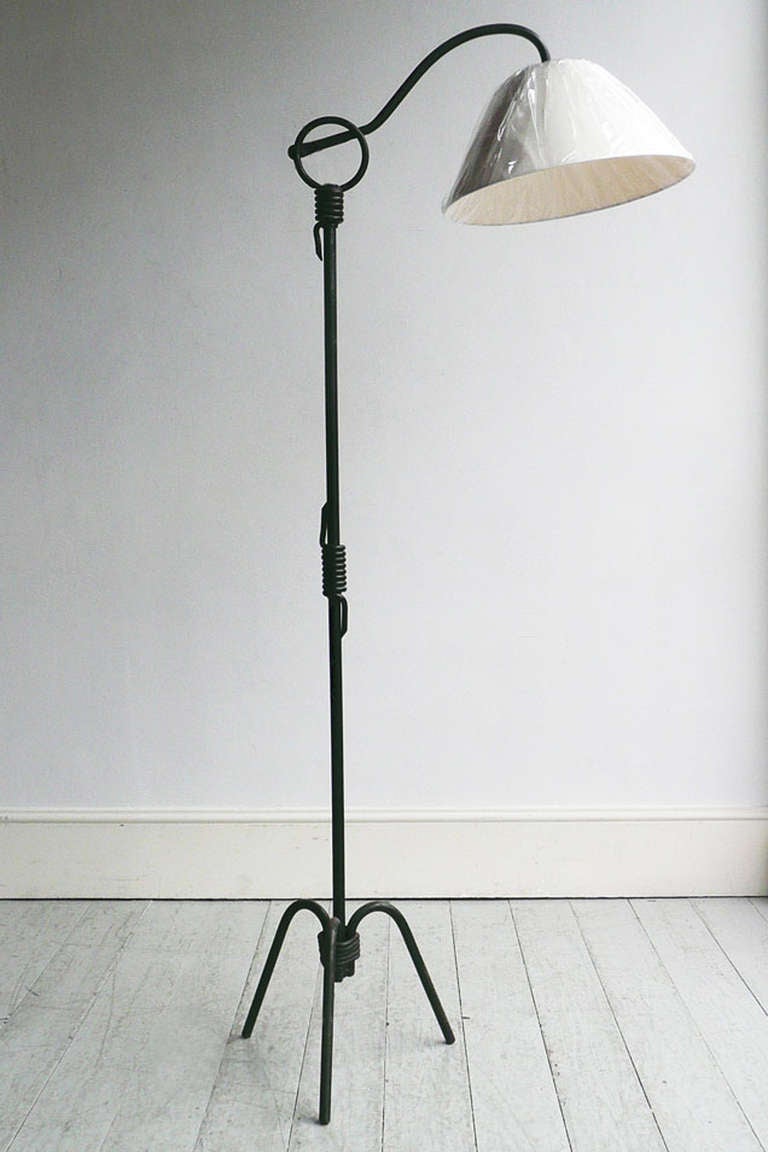 Dark green painted wrought iron with adjustable arm which can be raised, lowered and rotated. The angle of the lamp is also adjustable.