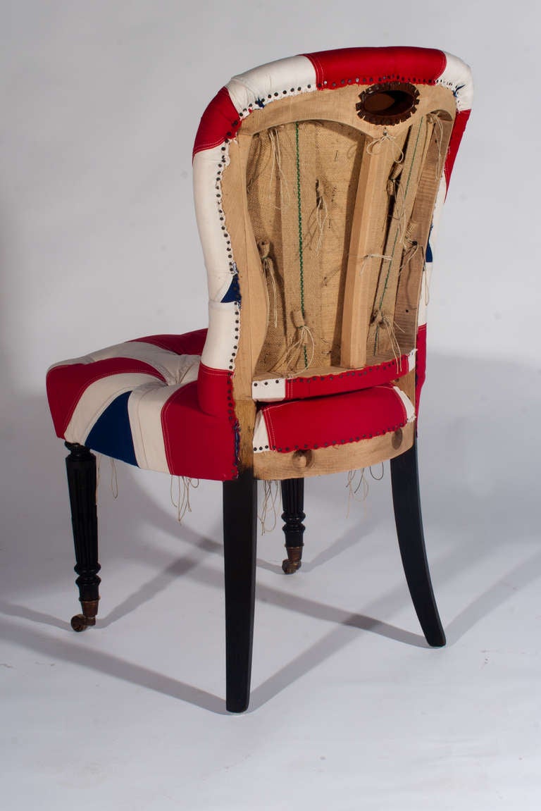 Union Jack Flag over deep buttoned hand stitched horse hair and individually tied in sprung seat on a hand made beech frame with open/deconstructed back, upon black painted beech legs with brass cup castors.