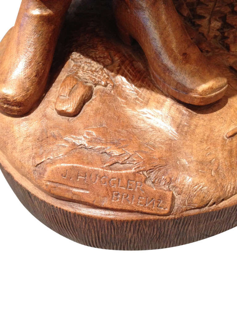 This is an exceptionally rare Swiss Black Forest walnut carving of a Hunter, carved by Johann Huggler. Finding pieces carved by Johann Huggler is extremely difficult since they are so rare, and we have owned only a handful of his carvings throughout