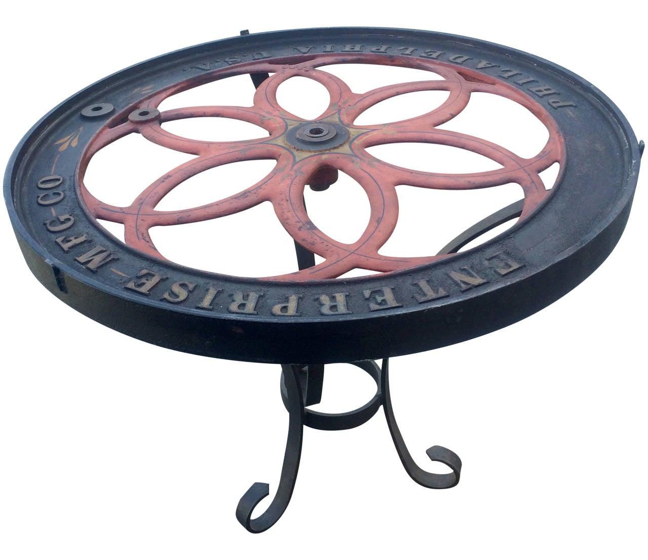 Wheel from a late 19th century coffee grinder outfitted into a great occasional table, this does have a glass top.