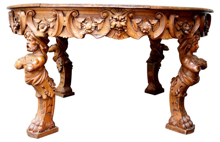 19th century Renaissance Revival figural carved round walnut table. Exceptional carving technique.