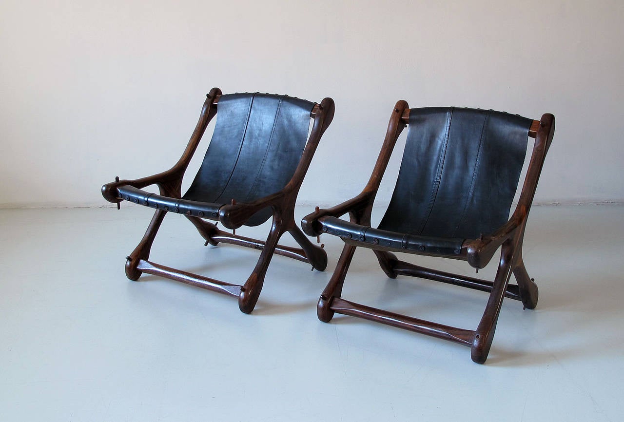 Rare Mid-Century Modern, Mexican 1960s Set of two Don S. Shoemaker slipper chairs.
Solid rosewood with black leather sling. Very good vintage conditon with some signs of use, and two missing wooden plugs on one of the bases.