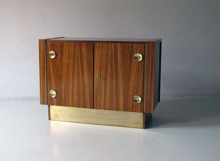 Hungarian Cabinet in Zebrano wood veneer with Maple wood venner interior and brass applications in perfect vintage condition. Carries a tag on the backside that suggests production of this piece in 1973. Solid brass applications to the doors and to