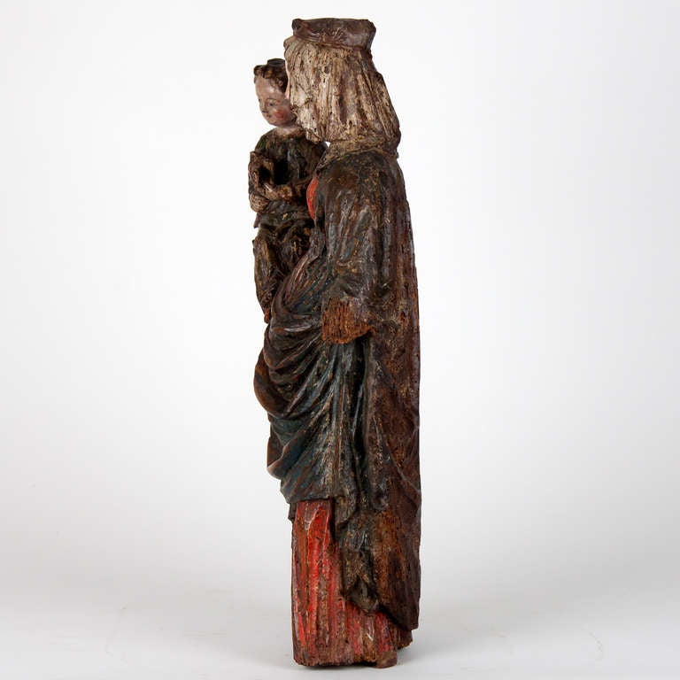 Important French Madonna and child circa 1380-1420 with remnants of original polychrome. 
Wear consistent with age.
The elm holes you see are no longer active and is of ancient date.