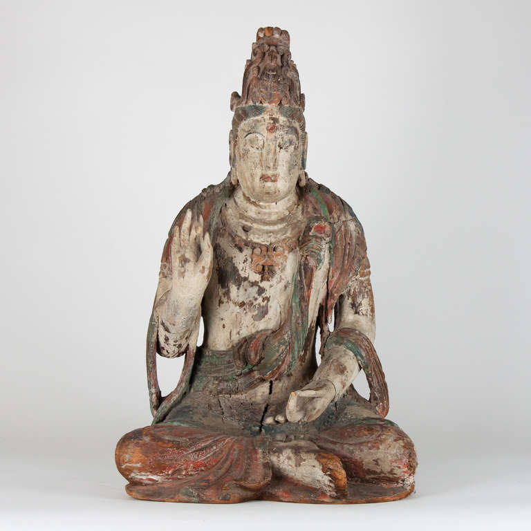 Seated Buddha with remnants of polychrome, china.
18th century or earlier
Missing a few fingertips, wear constistent with age.
Good condition.