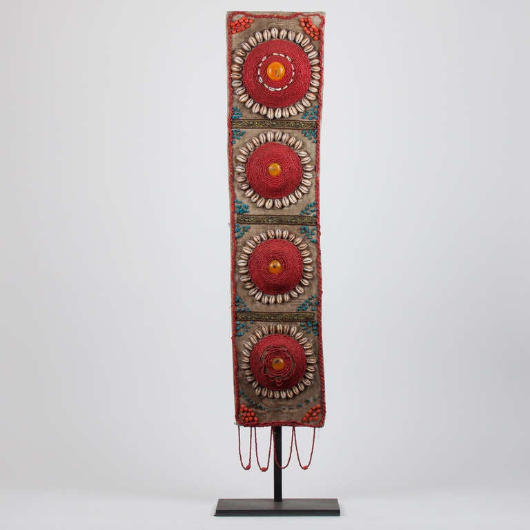 2nd part 19th century Tibetan beaded garment with turquoise, amber, cowrie shell on metal pedestal-stand in good condition, very ornamental.