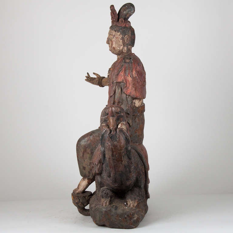 18th century wooden buddha sitting on a dragon, China.
18th c. or earlier.
Good condition with remnants of polychrome,wear consistent with age.
Missing a few fingertips.