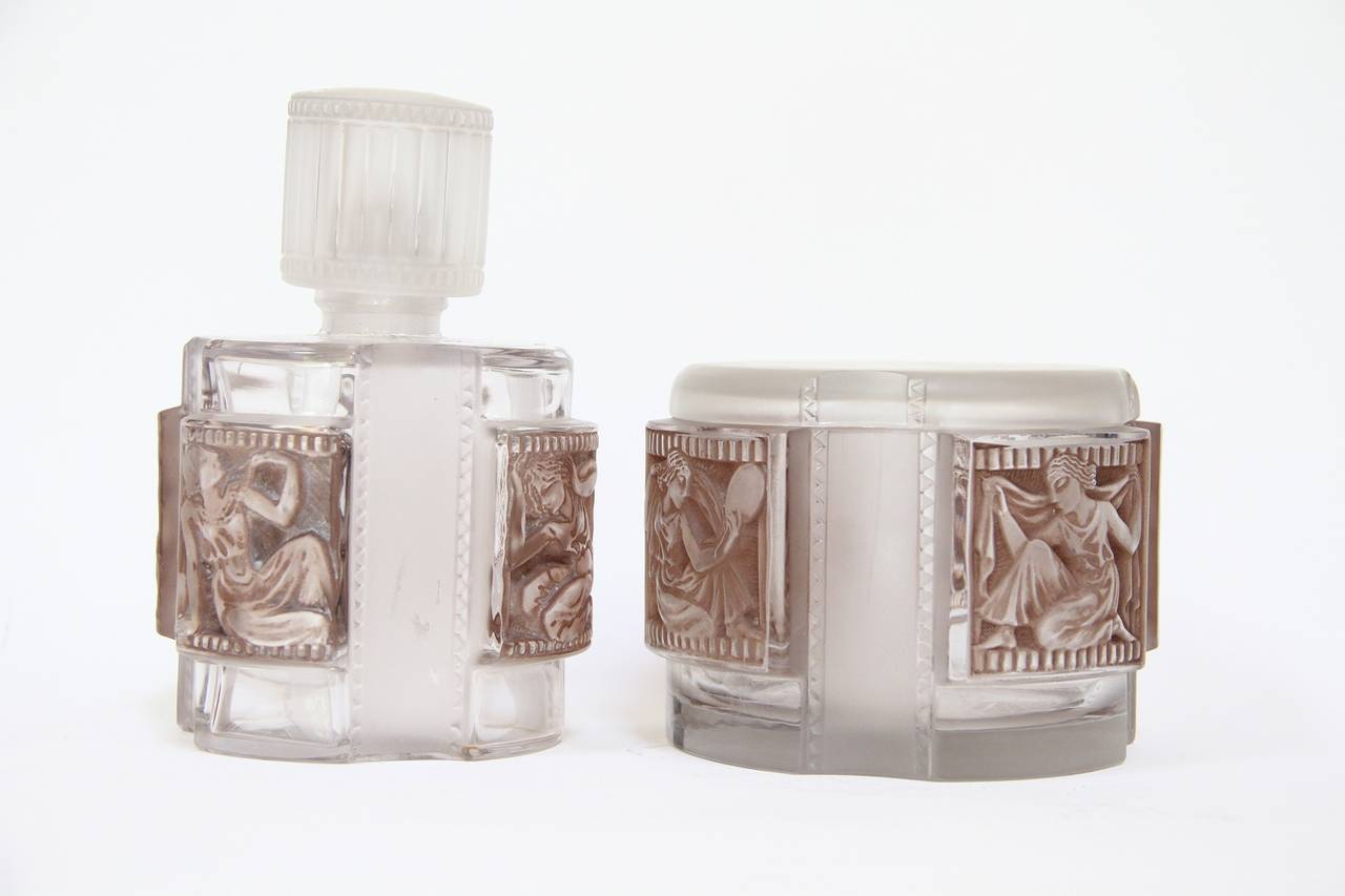 Rene Lalique Glass Helene Set
Garniture de toilette

Flacon n 1 
modele cree le 10 mars 1942
verre blanc souffle-moule patine satine et poli
haut. 23 cm
continue en 1947 sous le n 840, non repris apres 1951

Flacon n 2
modele cree le 10