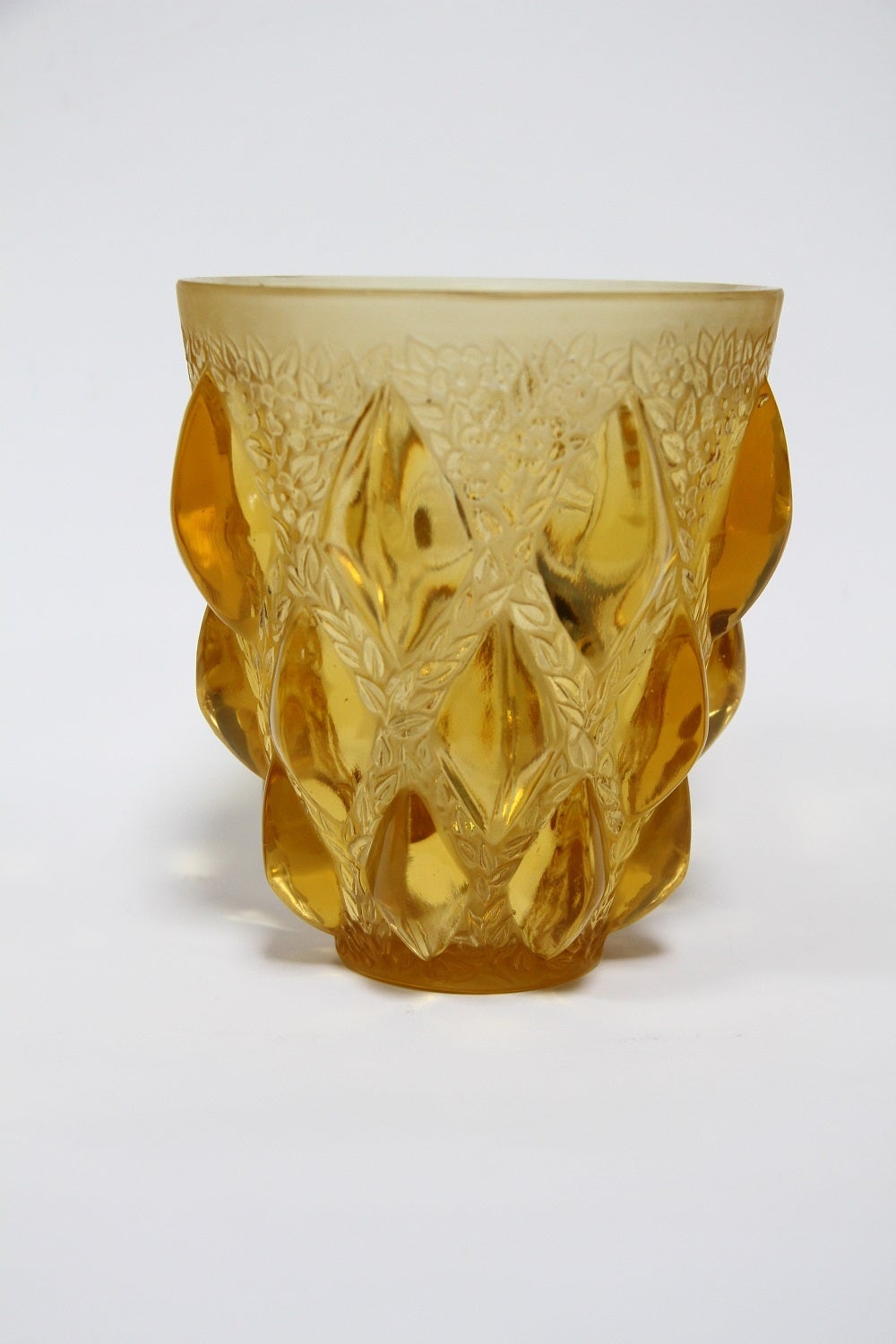 Rene Lalique Rampillon yellow color glass vase.
dit aussi vase - Cabochons et fleurettes 
modele cree le 8 mars 1927
verre blanc moule-presse opalescent et couleur (fume et jaune)
haut. 12.7 cm
figure aux catalogues de 1928 et de 1932
suprrime