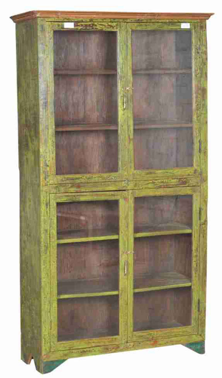 This is a Burmese teak cabinet painted a soft green with warm wood tones shining through.  We have two sets of glass doors enclosing lots of shelving.