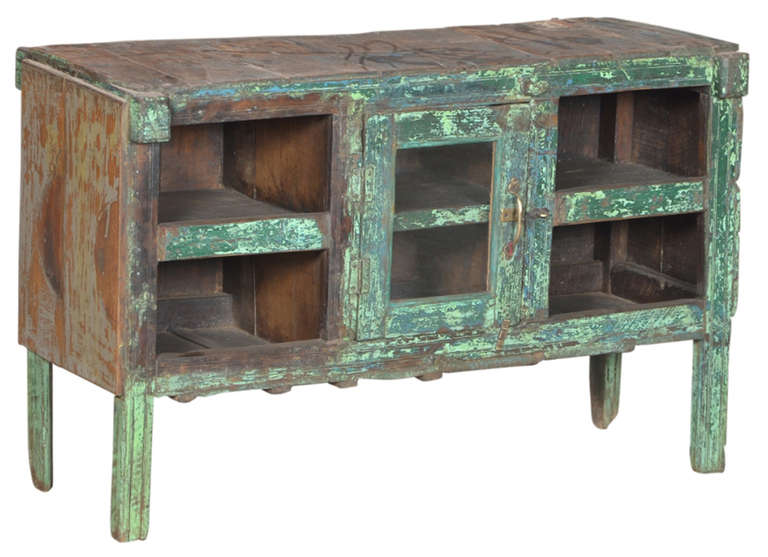 Here we have a primitive Burmese teak cabinet with amazing color and patina.
It would look great in an industrial or modern setting.  It has a wonderful patina  with warm wood tones shining through the old paint finish.