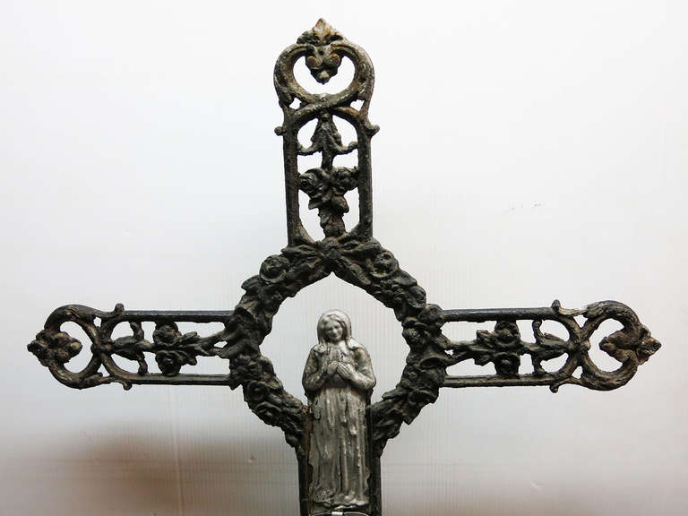 This is a French cast iron Cross that was formerly a grave marker in the late 19th Century.  It is fitted into a cement base measuring 12 wide by 10 deep by 9.5 inches high.  The base is in addition to the piece for a total height of 60.5 inches.
