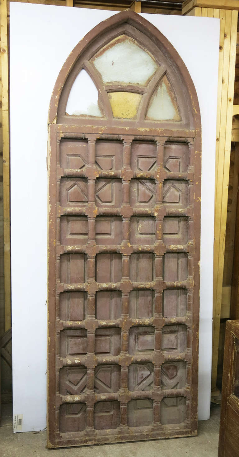 This is an early 20th Century Islamic style window with double wooden doors that open to reveal a lattice grate on the outside.  The wood has been painted many times but appears to be cedar underneath.