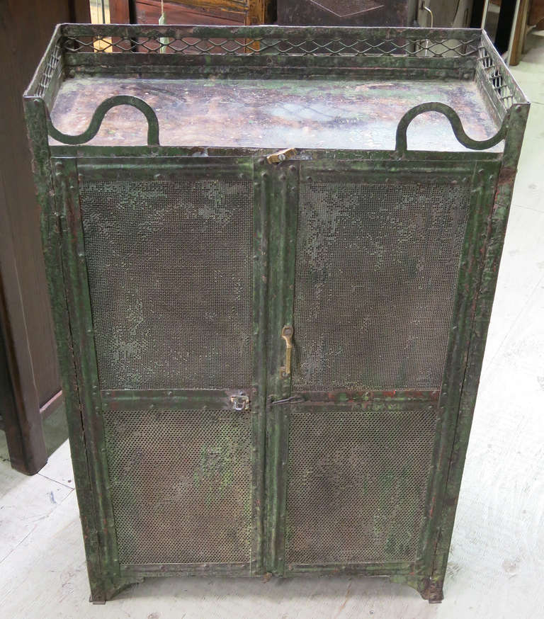 This is a great Mid Century Industrial cabinet that would work well in a bedroom or bathroom to hold cosmetics, toiletries or linens and towels.  It has mesh doors and a lovely gallery around the top of the piece.
