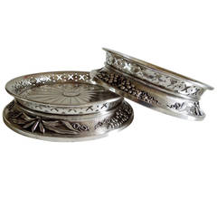A rare pair of silver-plate wine coasters made by the Maison Christofle.