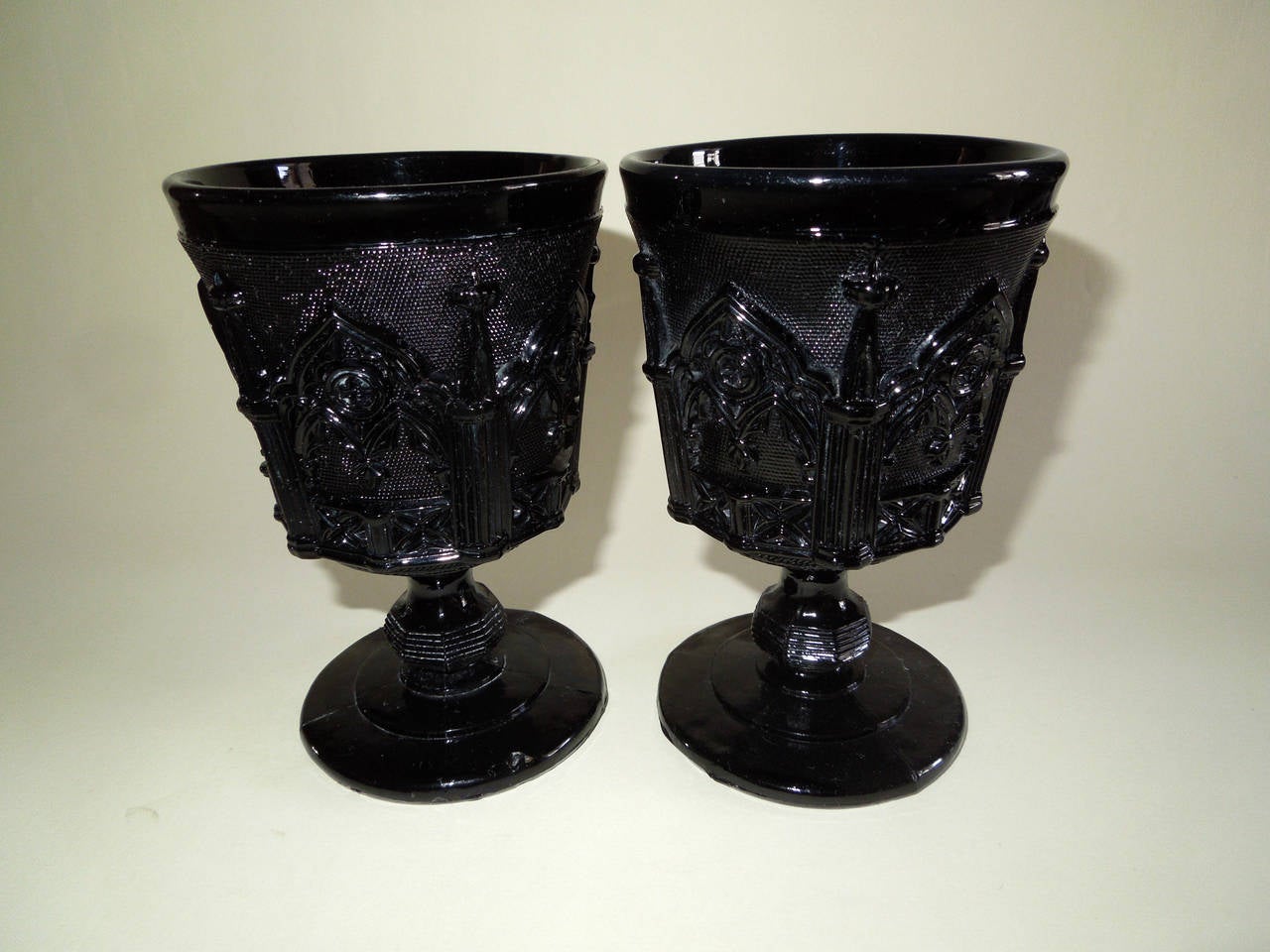 Two Gothic Revival pressed opaque black glass wine or water goblets, made by the Cristalleries Saint Louis. There is another example in the Paris, Musée des Arts Décoratifs.