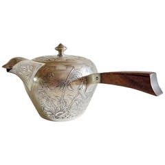 A silver teapot with engraved japonisme decoration by Veyrat.