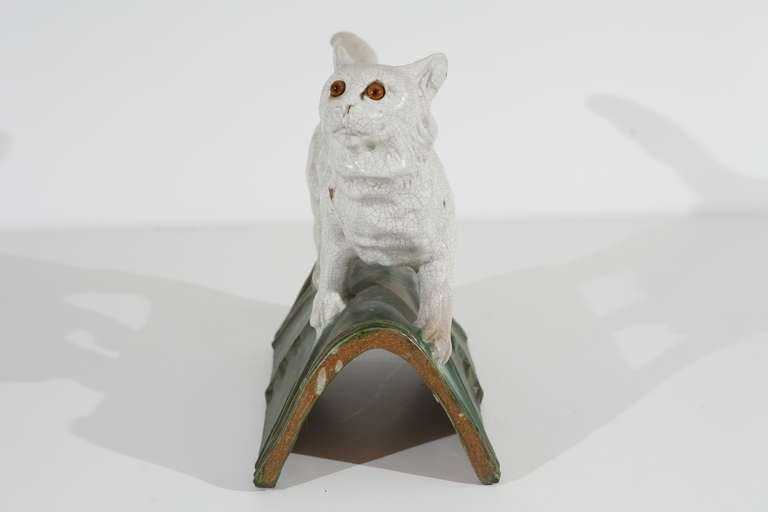 A mid-late 19th century ceramic cat roof tile from a house in Normandy.
Glazed ceramic roof tile and body with inset, original glass eyes.