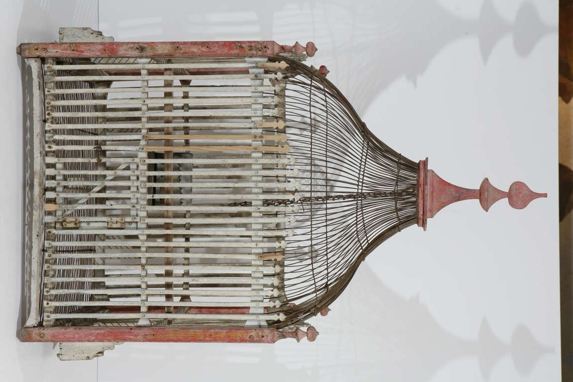A red and cream painted wood & metal wire bird cage; made in France, c. 1830