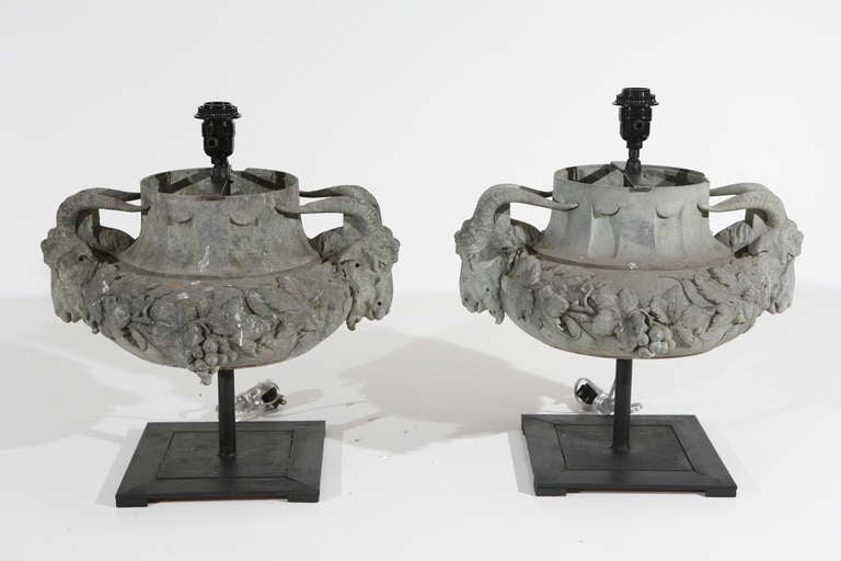A pair of lead lamps with ram's head decorations. Shades available at cost of $650 for the pair. Shade size 10